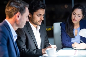 Group of businesspeople looking at document in the office